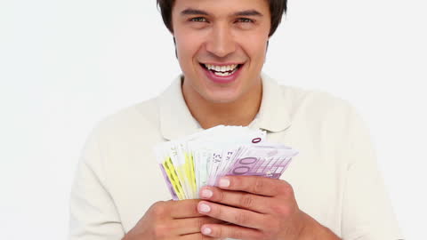 Happy Man Holding Euro Currency Notes Smiling at Camera