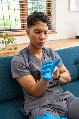 Young medical professional wearing gloves in clinic environment