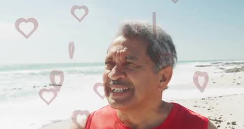 Elderly Man Surrounded by Hearts On Sunny Beach