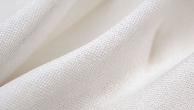 White woven textile showing fine weave and soft folds for backgrounds