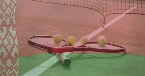 Tennis Rackets and Balls on Outdoor Court with Net