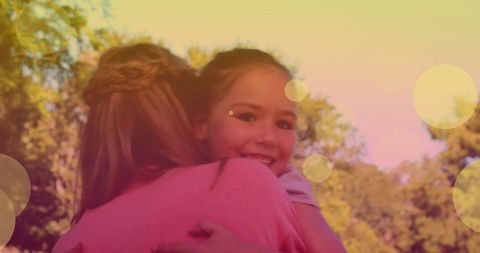 Mother and Daughter Sharing Warm Hug Outdoors