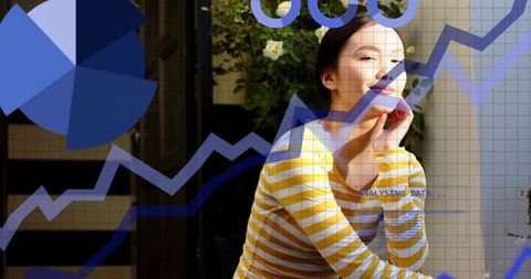 Smiling asian woman resting chin on hand on balcony with analytics overlay