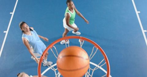 Diverse Female Basketball Players Competing Match Tracking Ball