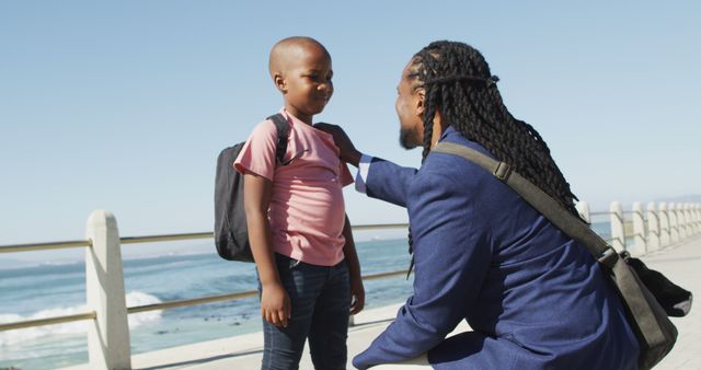 Father Encouraging Son by Ocean on Sunny Day - Download Free Stock Images Pikwizard.com