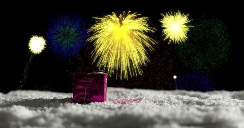 Christmas Present in Snow with Vibrant Fireworks