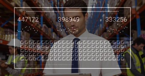 Warehouse manager monitoring augmented reality inventory dashboard on tablet amid busy depot