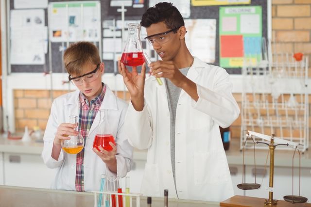 Attentive Schoolboys Conducting Chemical Experiment in Laboratory - Download Free Stock Photos Pikwizard.com