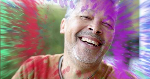 Laughing Mature Man Wearing Necklace and Red Shirt with Vibrant Color Overlay Portrait