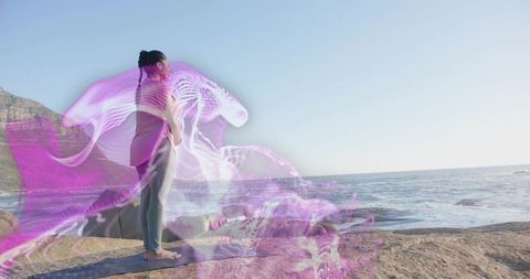 Woman Practicing Yoga on Rocky Shore with Ethereal Light Trails