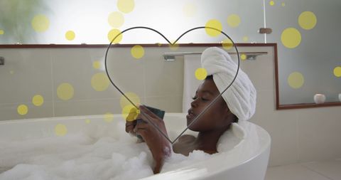 African American woman enjoys a cup of coffee while relaxing in a modern bathtub filled with bubbles. The scene is digitally enhanced with a heart overlay and floating yellow circles, suggesting a theme of relaxation and self-care. Perfect for use in content about wellness, self-gratitude practices, bathroom interiors, or luxurious beauty products.