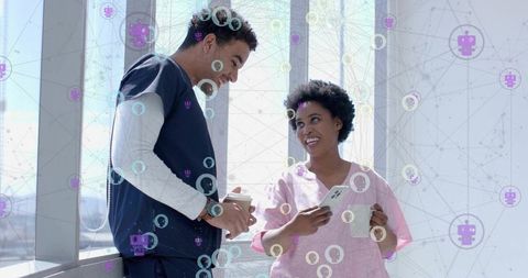 Medical Professionals Discussing Innovations in Hospital Corridor