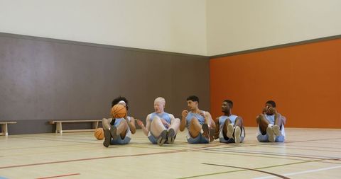 Youth basketball team bonding during training in gym