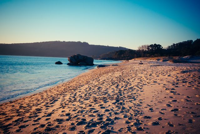 Serene Sunset Beach with Tranquil Ocean Waves - Download Free Stock Photos Pikwizard.com