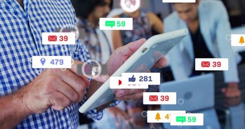 Man tapping tablet while social engagement badges multiply and team monitors analytics
