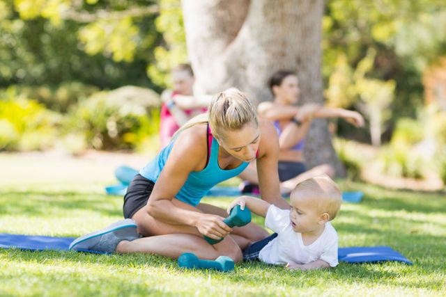 Woman with her baby while exercising in park