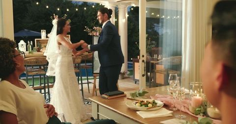 Bride and Groom Dancing During Reception with Dining Guests