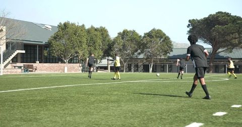 Soccer Players Training at Field with Clear Sky