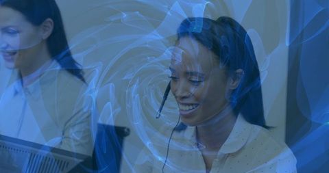 Smiling call center agent wearing headset with digital swirl