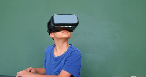 Young boy engaging with virtual reality in classroom