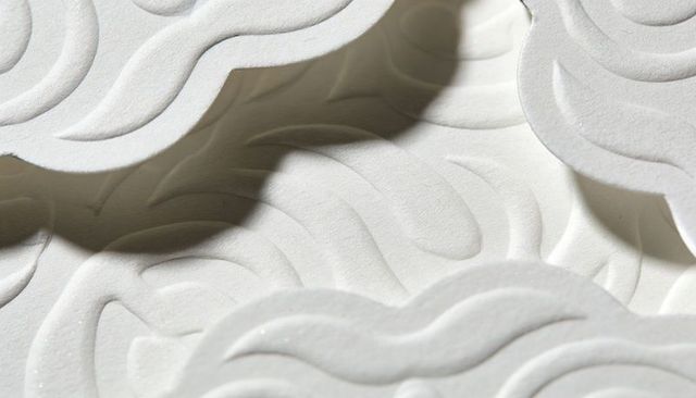 White embossed wave foam panels creating soft shadows, scalloped edges and textured relief