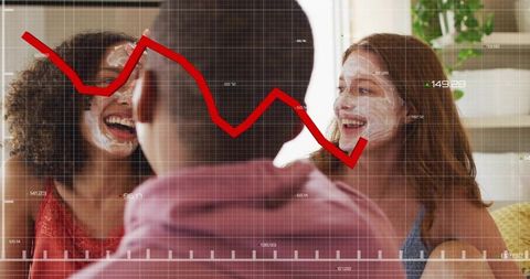 Laughing friends wearing facial masks in sunlit living room with red graph overlay