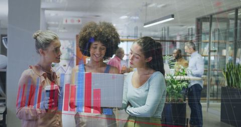 Diverse Team Analyzing Graphical Data in Modern Office Environment