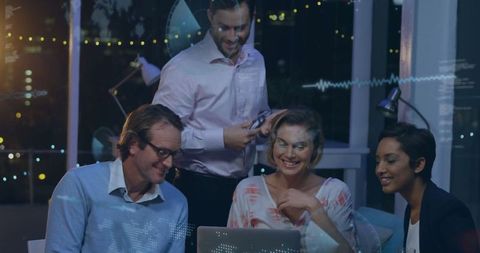 Innovative team collaborating on data in nighttime office