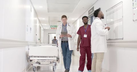 Diverse Medical Team in Hospital Corridor Reviewing Data - Download Free Stock Images Pikwizard.com