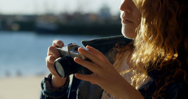 Woman Adjusting Camera, Preparing for Outdoor Photography - Download Free Stock Images Pikwizard.com