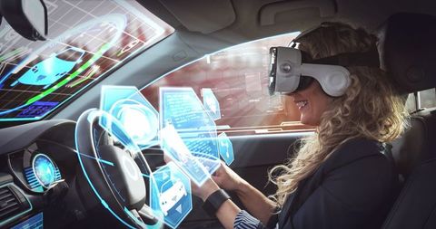 Woman experiencing vr in autonomous car with futuristic interface