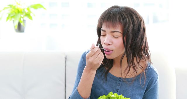 Young Woman Enjoying Healthy Salad in Bright Living Room - Download Free Stock Images Pikwizard.com