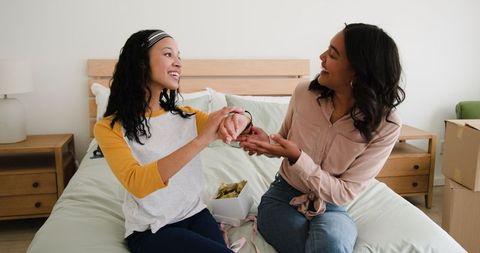Mother and Daughter Bonding While Unpacking Boxes at Home