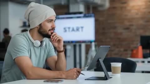 Focused Bearded Man Using Tablet in Modern Office