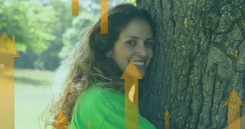 Smiling woman hugging tree in eco conservation concept