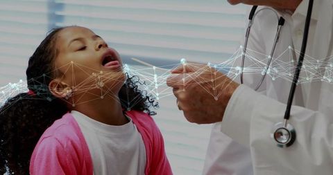 Pediatric check-up: doctor examining girl's throat