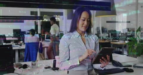 Smiling Businesswoman Analyzing Financial Data on Tablet in Office