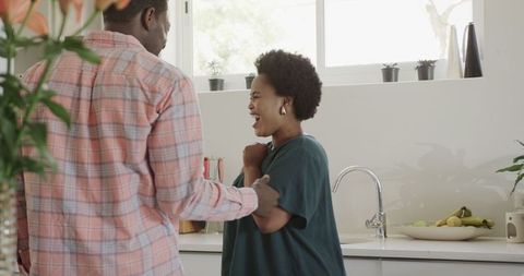 Joyful Couple Sharing a Moment in Home Kitchen