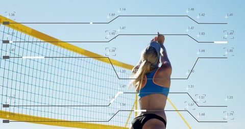 Energetic female athlete jumping at beach volleyball court