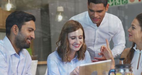 Diverse Team Collaborating on Tablet