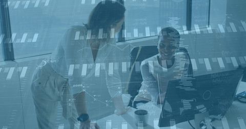 Diverse female colleagues analyzing financial data on computer