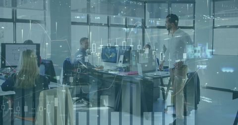 Business team collaborating with digital financial graph in office