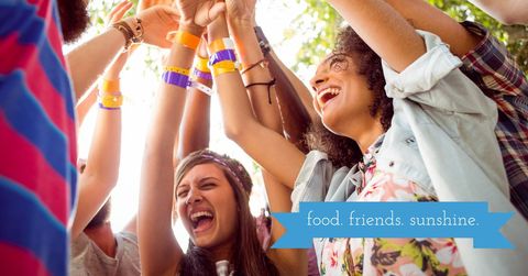 Group of friends celebrating together under sunny sky