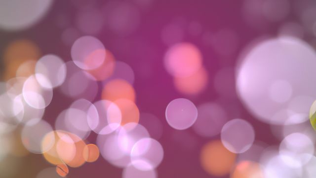 Abstract bokeh background with soft shades of pink and purple. Can be used for festive designs, party invitations, or any project requiring a dreamy, light-filled backdrop.