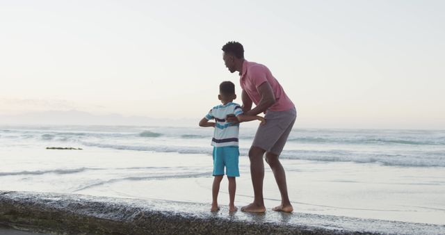 Father and son playing together at the beach during sunset - Download Free Stock Images Pikwizard.com