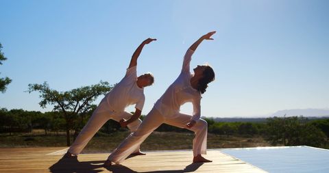 Couple Practicing Yoga Outdoors for Relaxation