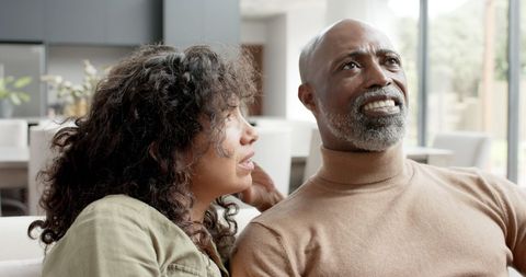 Smiling Biracial Couple Relaxing Together in Modern Home - Download Free Stock Images Pikwizard.com