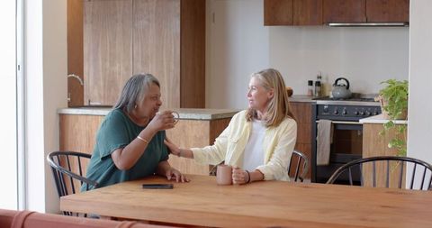 Diverse Friends Sharing Conversation in Modern Kitchen