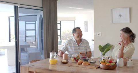 Senior Couple Enjoying Leisurely Breakfast in Cozy Home Setting