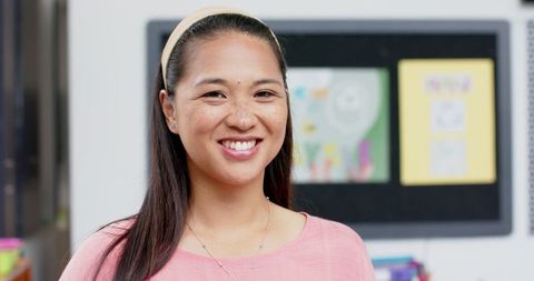 Smiling Teacher in Classroom for Educational Inspiration